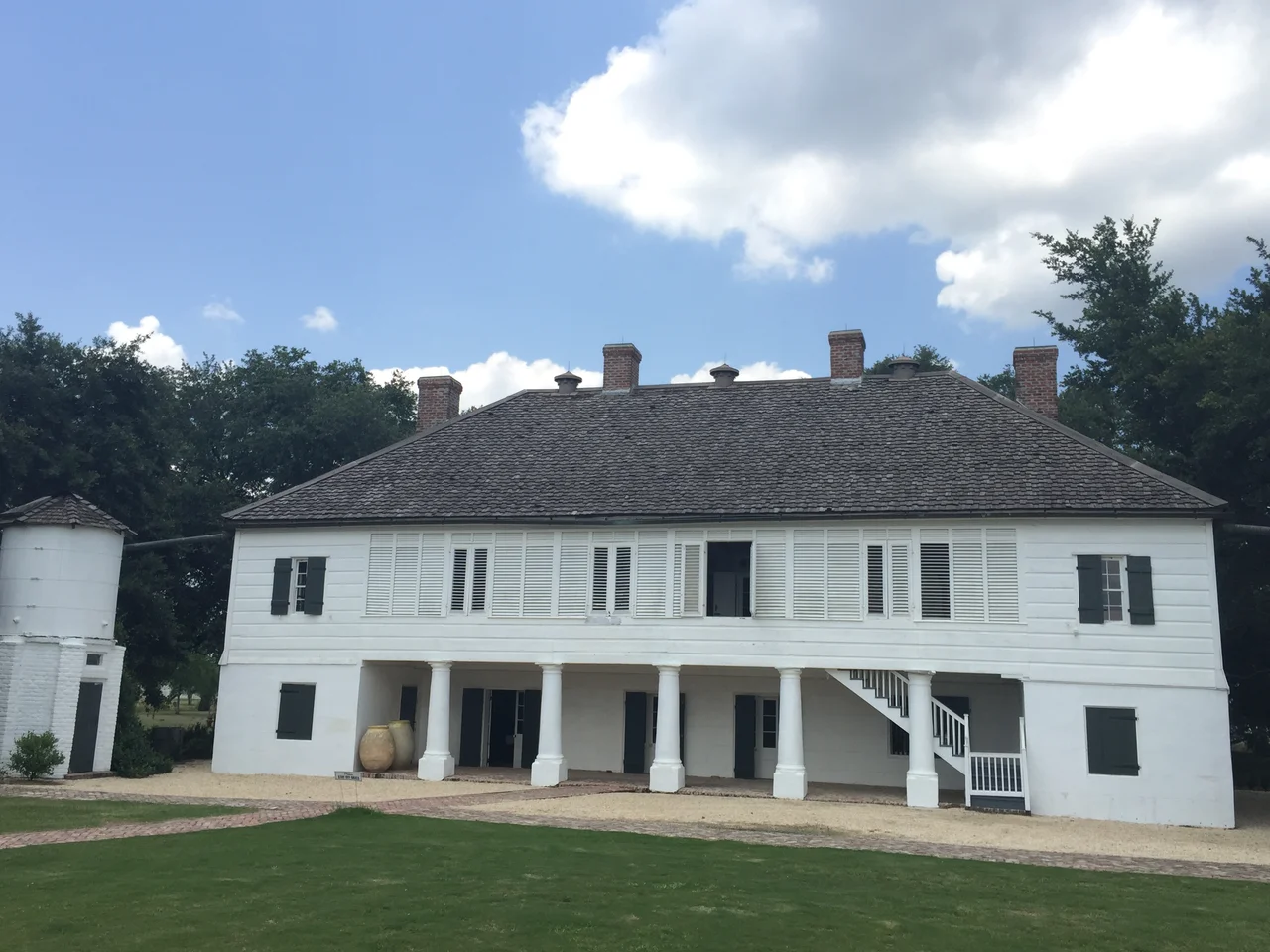 The Big House.  Raised French Creole style cottage was built of masonry and cypress in the late 18th century. It is one of the earliest and best preserved Creole plantation houses standing on River Road. Sometime prior to 1815, the Big House was expanded to its present configuration with seven rooms on each level, plus a full-length gallery across the front and an open loggia facing the rear. This is also one of the very few historic American houses known to have received decorative wall paintings on both its exterior and interior.