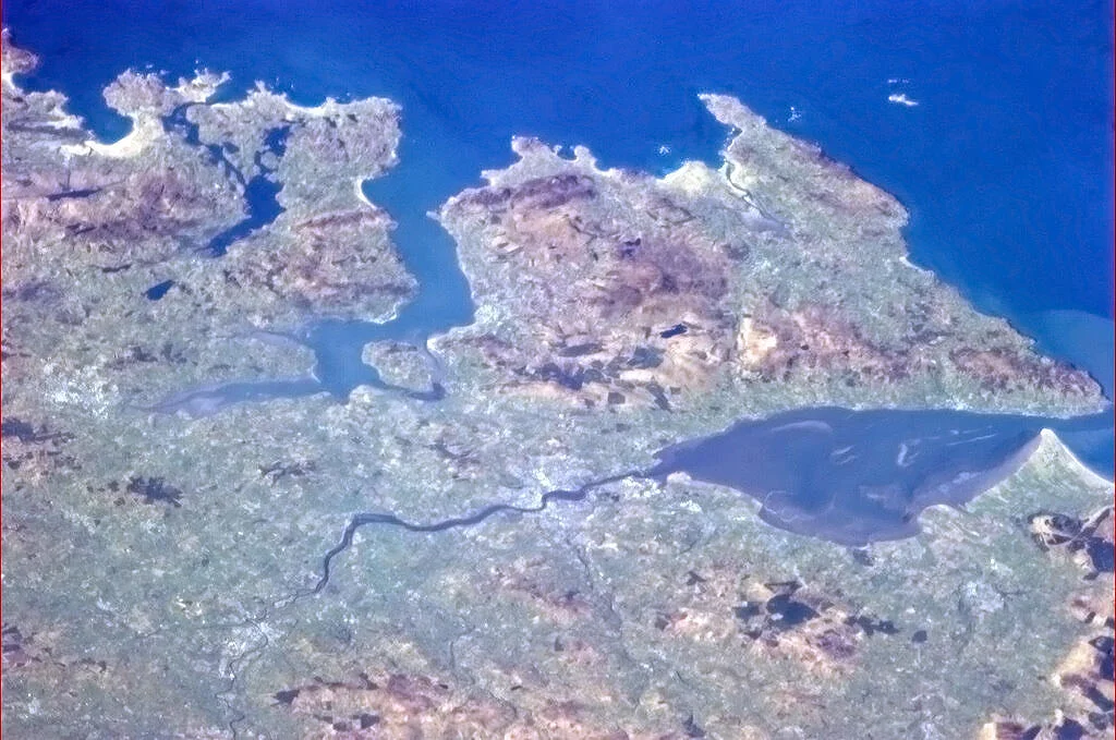 "Derry, Northern Ireland, and the rugged coast facing the North Atlantic." – Caption by astronaut Chris Hadfield on board the International Space Station.
This is one of a set of eight pictures of Ireland taken from earth orbit that were posted on the internet by Hadfield to celebrate Saint Patrick's Day in 2013.
The Inishowen Peninsula on the north coast of Ireland stands out clearly in this picture, surrounded by Lough Swilly (left) and Lough Foyle (right). The dark River Foyle winds through the countryside and empties into Lough Foyle at the city of Derry.