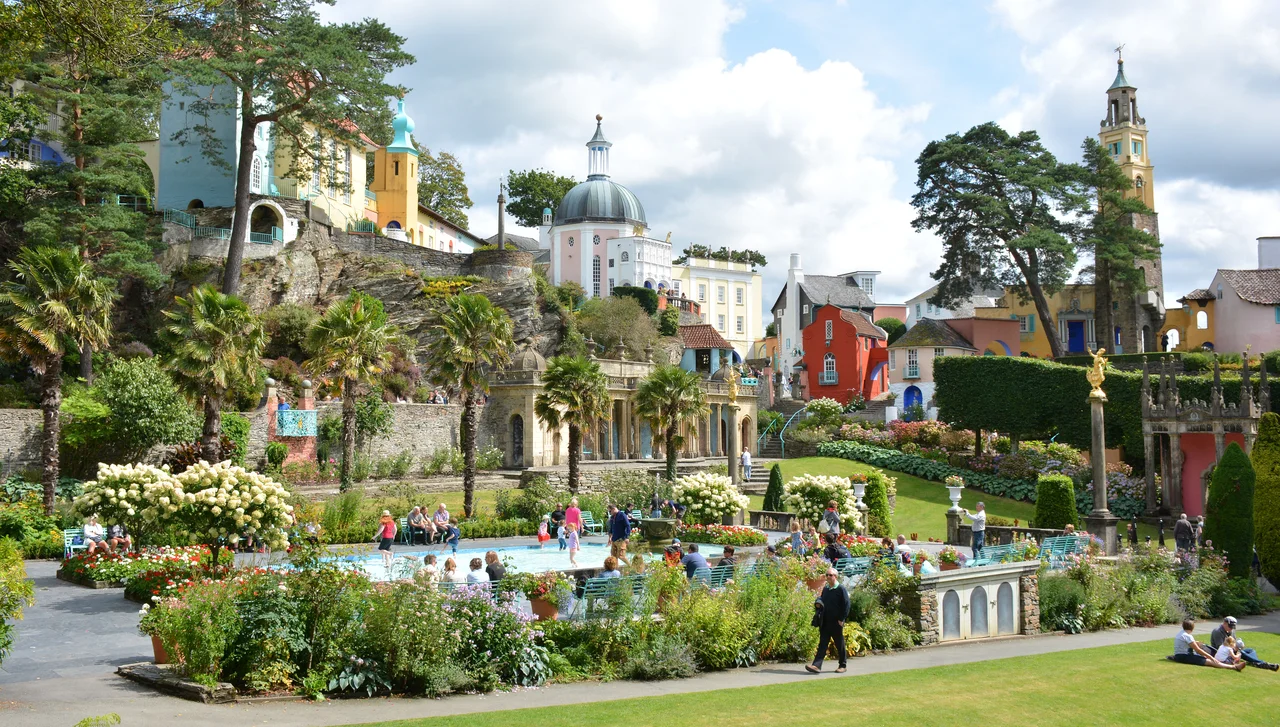 This hotel and tourist attraction in north Wales was catapulted into fame by the 1960's cult TV series "The prisoner" starring Patrick McGoohan.
From Wikipedia: 
The village of Portmeirion has been a source of inspiration for writers and television producers. Noël Coward wrote Blithe Spirit while staying there. George Bernard Shaw and H. G. Wells were also early visitors. In 1956 the village was visited by architect Frank Lloyd Wright, and other famous visitors have included Gregory Peck, Ingrid Bergman and Paul McCartney. 

The village has many connections to the Beatles too. Their manager, Brian Epstein was a frequent visitor and George Harrison spent his 50th birthday in the village in 1993. It was while Harrison was in Portmeirion that he filmed interviews for The Beatles Anthology documentary.