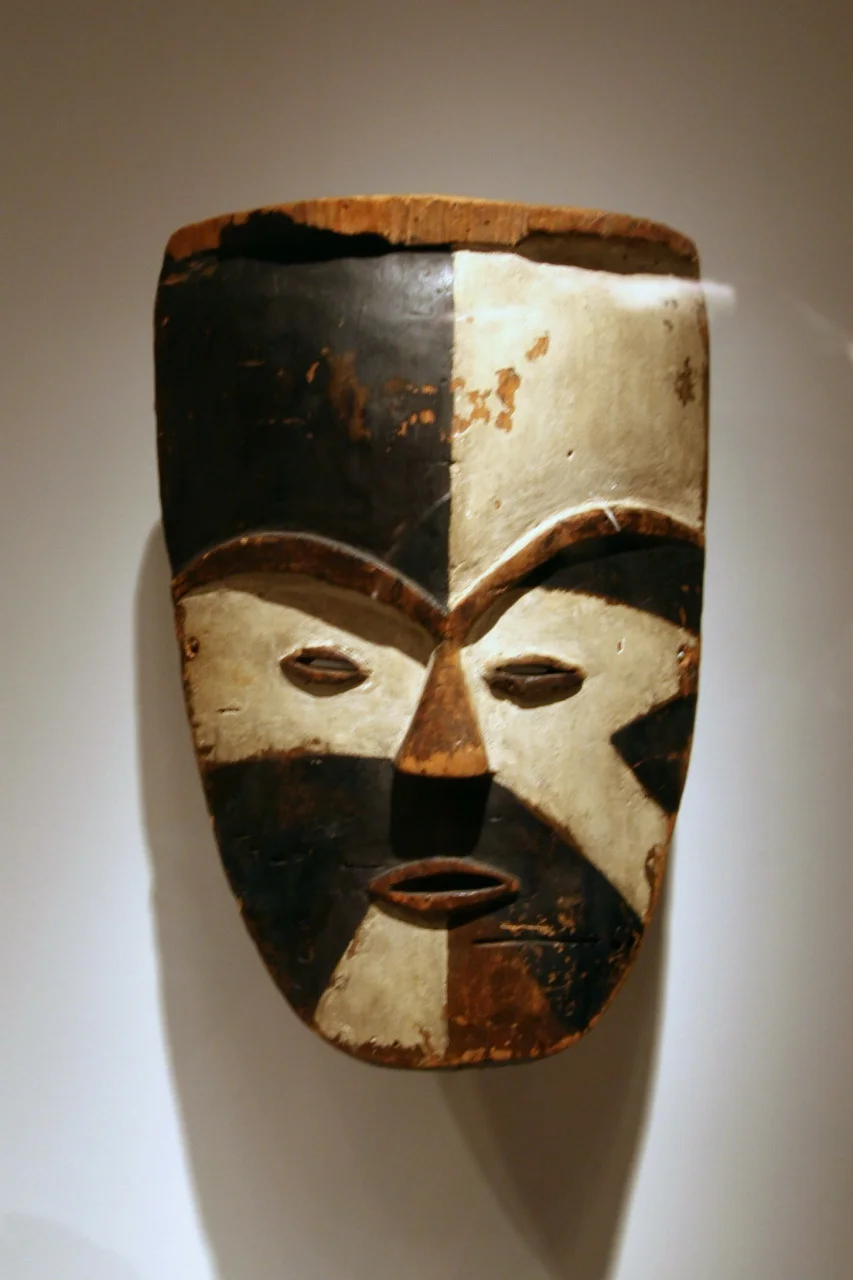 Mask, Tsogo peoples, Ogowe River region, Gabon, Late 19th to early 20th century, Wood, pigment
The striking disconnect between the divisions of the painted surface and the underlying carved form is an aspect of African art that first entranced Western audiences. The Western lack of awareness of context was such that when this mask was exhibited in the 1950s in France, it was identified as coming from another part of Africa. Later research attributed this mask to the Tsogo peoples as part of wider regional tradition of divided color faces.

(National Museum of African Art)