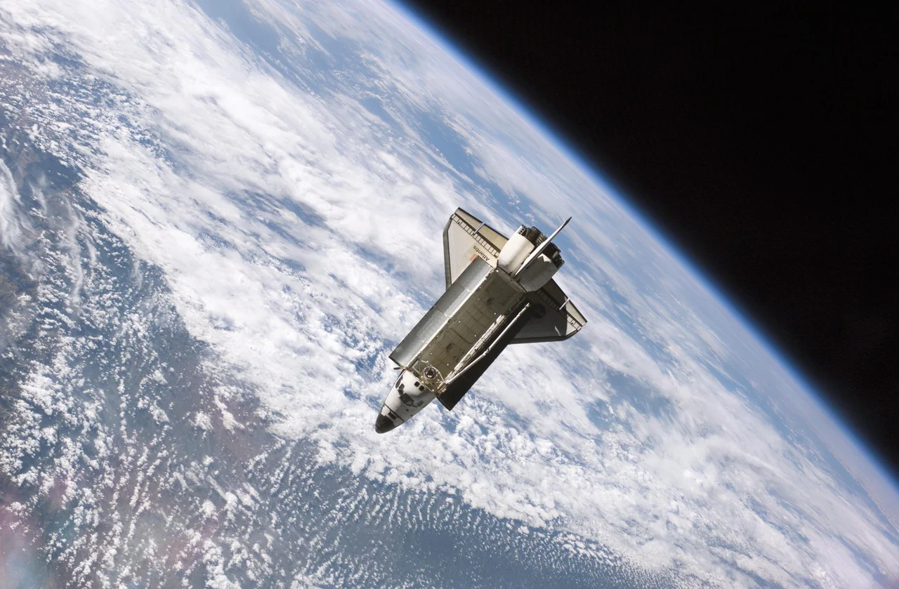 The Space Shuttle Atlantis, backdropped against clouds over Earth, is pictured after it undocked from the International Space Station at 7:50 a.m. CDT, Sept. 17, 2006. The STS-115 astronauts completed six days, two hours and two minutes of joint operations with the station crew.